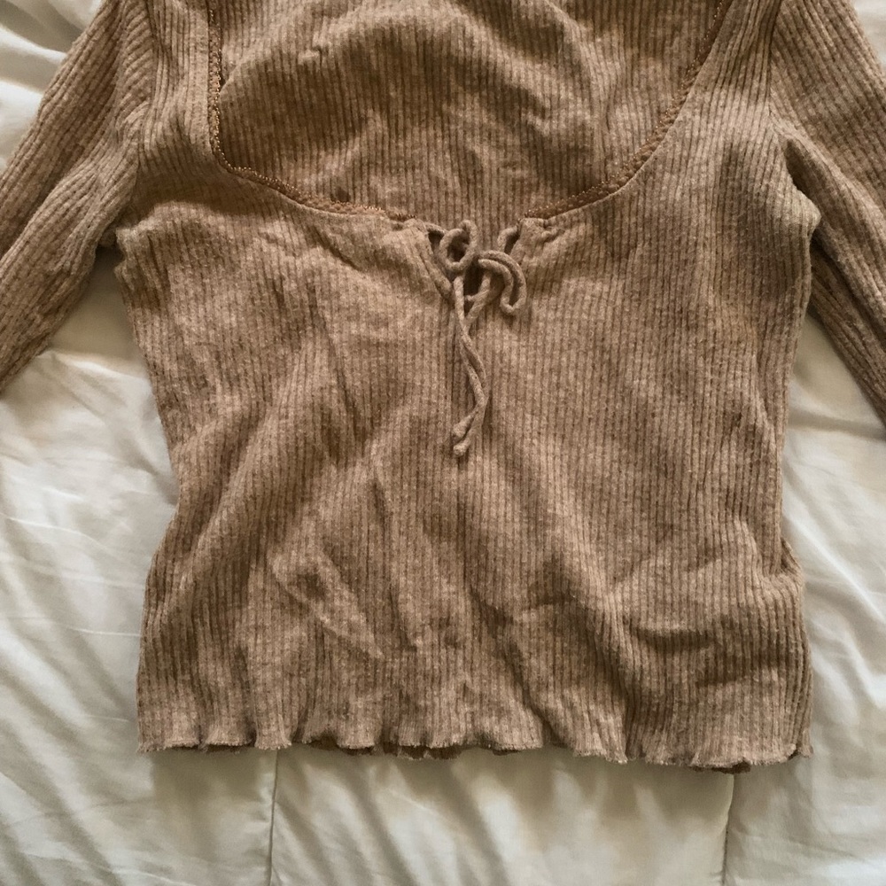 Brownish, lace-neck top with a little self-tie in the front.